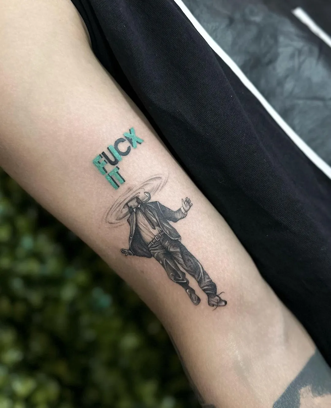 Tatuaj fine line pe braț cu o siluetă de cowboy și text