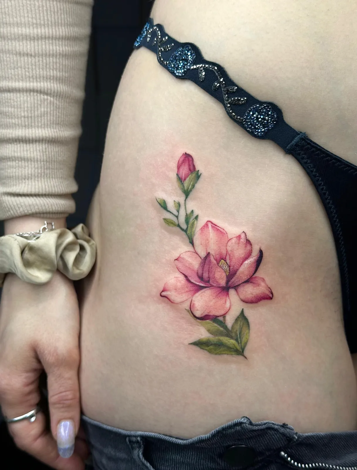 Tatuaj color pe coaste cu o magnolie roz